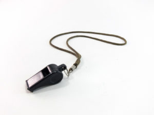 Black plastic whistle with cord on white background