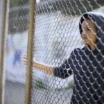Child Behind a Fence