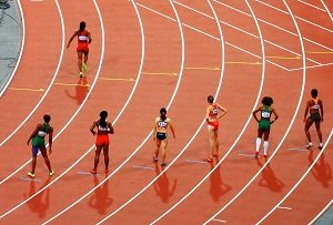 Runner in track race starting before other racers