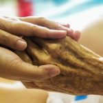 hand holding hospice patients hand