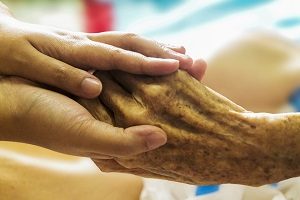 hand holding hospice patients hand