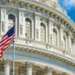 close up of capitol dome with United States flag