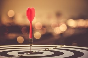 red dart on bulls-eye target