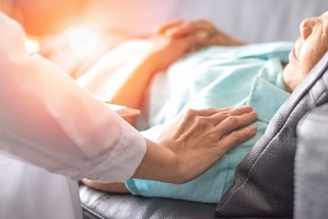 doctor touching hospice patient