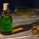 Bottle of Green Liquid with Empty Bottles Around