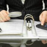 Businessman Examining Books and Records