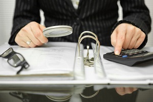 Businessman Examining Books and Records
