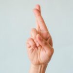 Person's Hand with Fingers Crossed