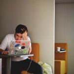 Person Working on Laptop Stressed with Hand on Head