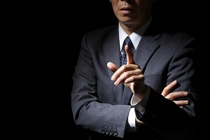 Businessman Under Dark Shadow Pointing Finger