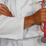 Doctor Holding Stethoscope with Crossed Arms