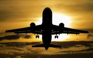 plane in sky at sunset
